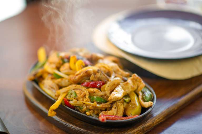 sizzling fajitas on a plate